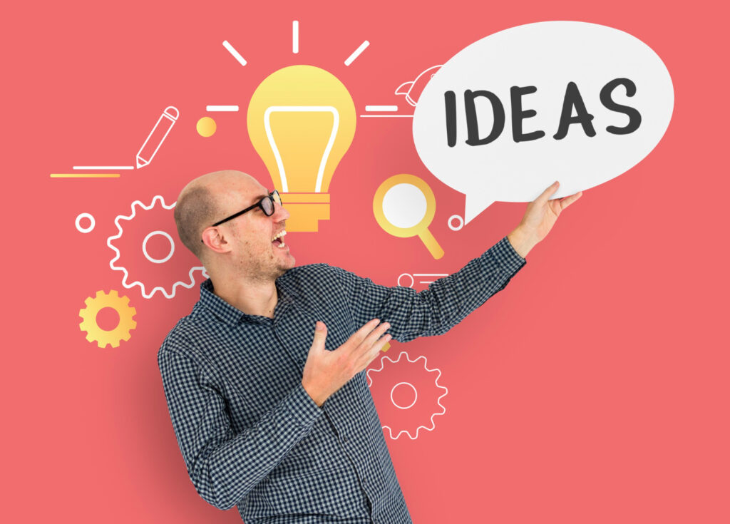 Un homme tenant une bulle avec le mot "IDEAS" pour exprimer le concept de recherche d'idées.